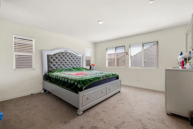 a bedroom with a bed and a dresser