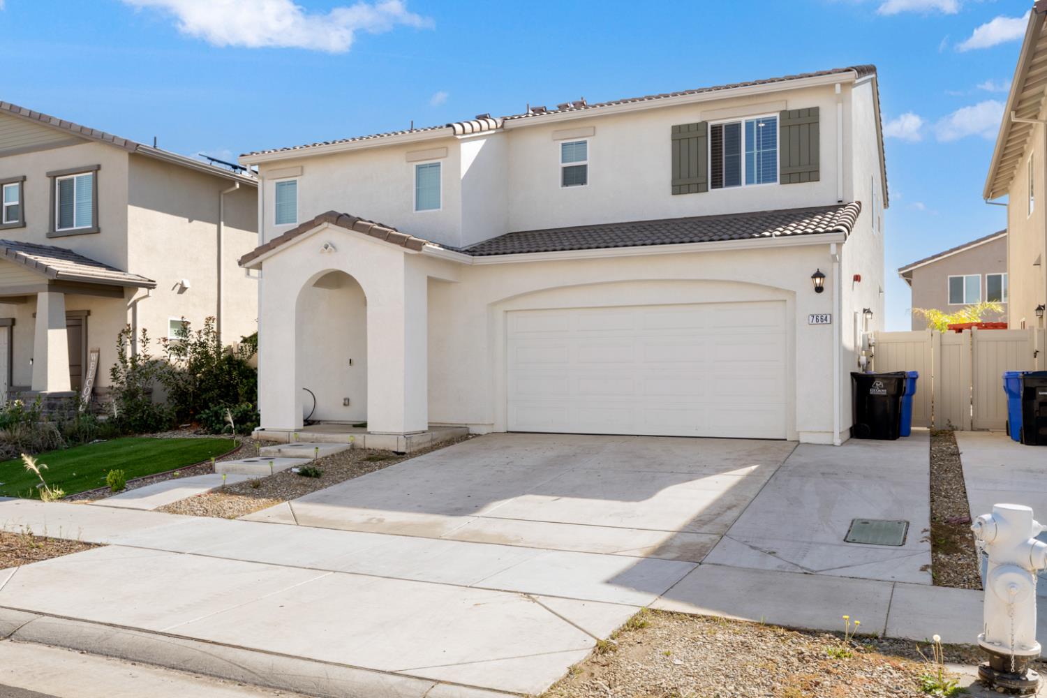 7664 Walpole Way Elk Grove, CA 95758 - Photo 2 of 43 a front view of a house with a yard and garage