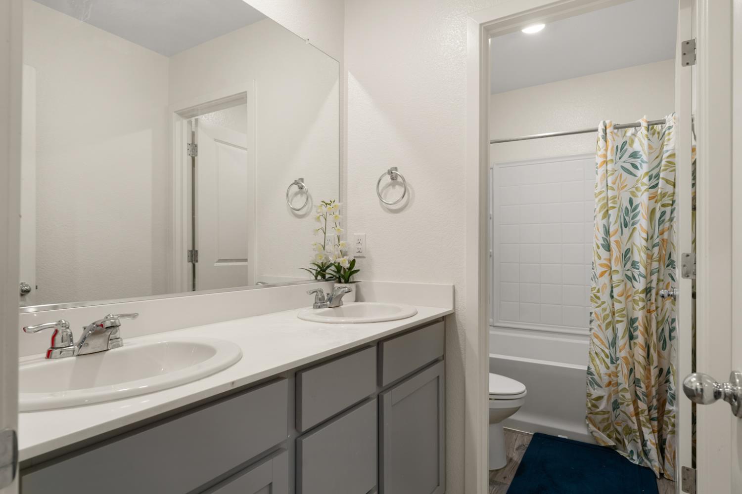 7664 Walpole Way Elk Grove, CA 95758 - Photo 22 of 43 a bathroom with a sink a toilet and shower