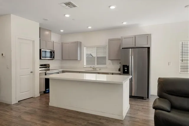 a kitchen with a sink stove and microwave