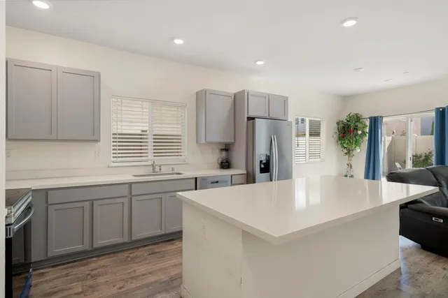 a kitchen with stainless steel appliances a refrigerator sink and stove