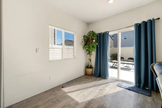 a bedroom with a bed and a lamp on dresser