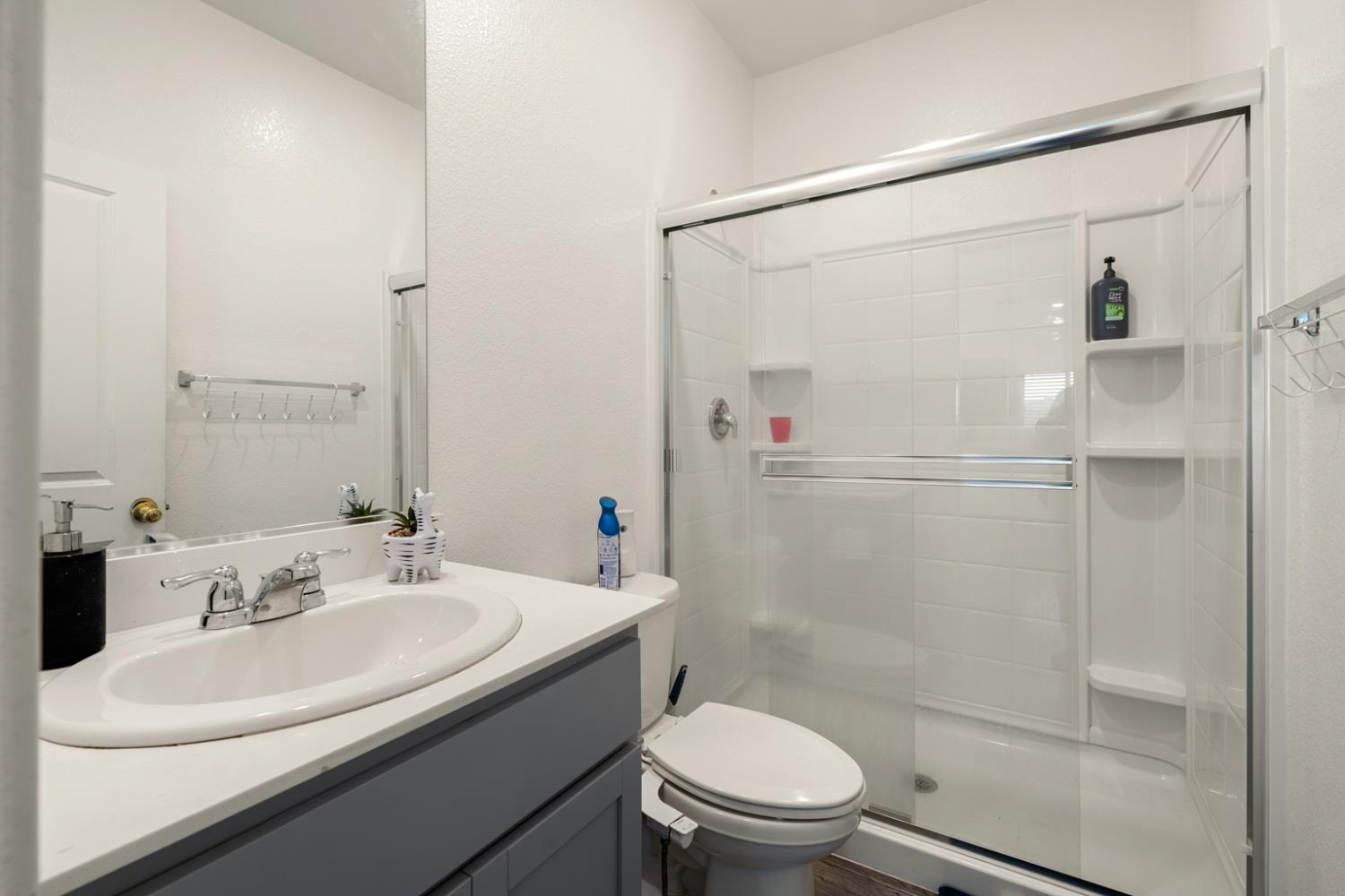 7664 Walpole Way Elk Grove, CA 95758 - Photo 33 of 43 a bathroom with a sink toilet and shower