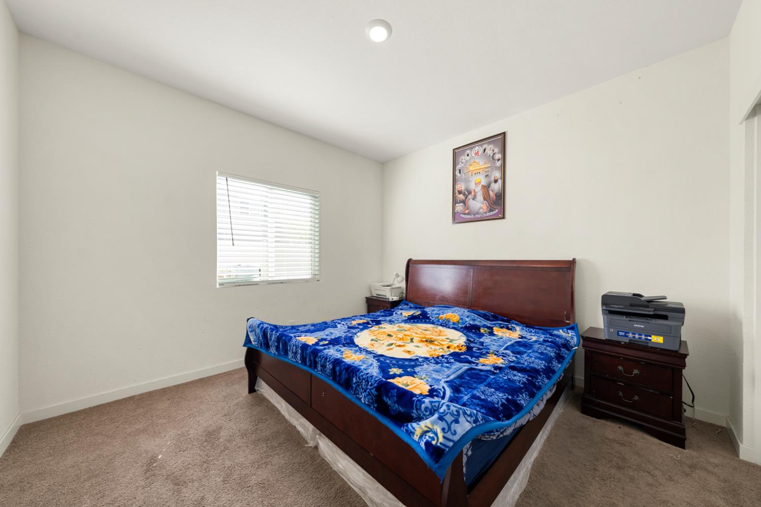 7664 Walpole Way Elk Grove, CA 95758 - Photo 34 of 43 a bedroom with a bed and a lamp on dresser