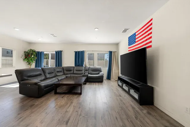 a living room with fireplace furniture and a flat screen tv