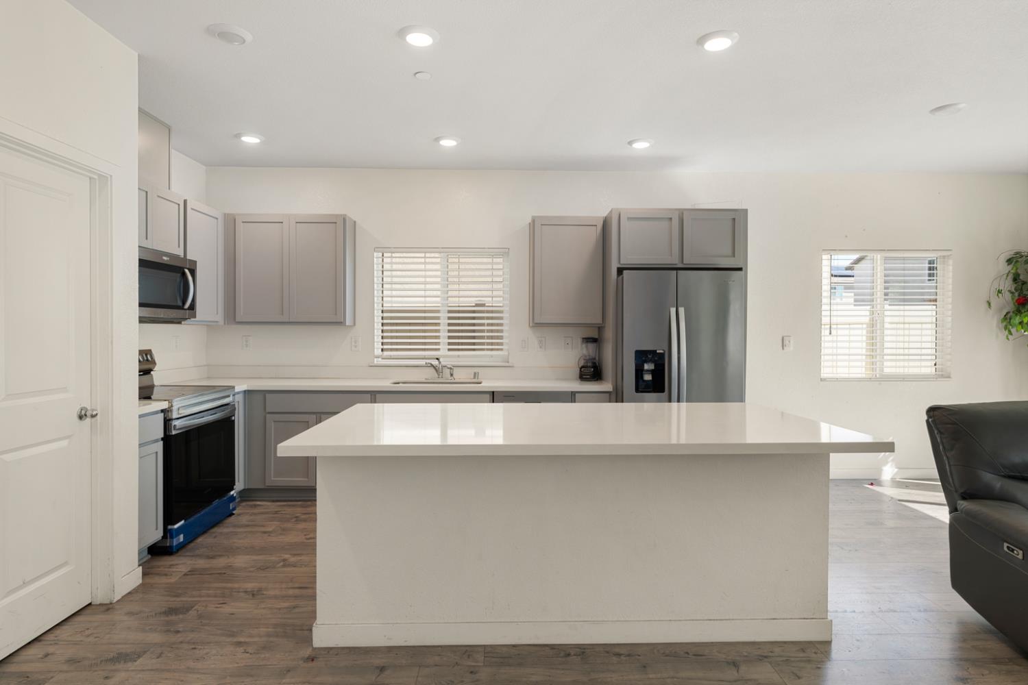 7664 Walpole Way Elk Grove, CA 95758 - Photo 10 of 43 a kitchen with stainless steel appliances granite countertop a sink stove and refrigerator