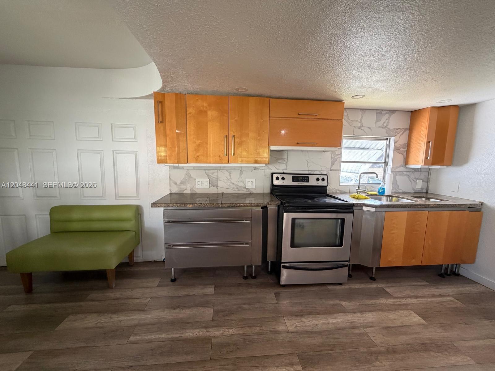 5331 Southwest 35th Street Davie, FL 33314 - Photo 7 of 31 a kitchen with green cabinets and a wooden floor