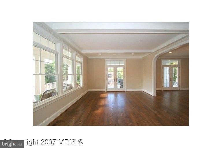 7003 Brookville Road Chevy Chase, MD 20815 - Photo 3 of 12 a living room with a large window and wooden floor