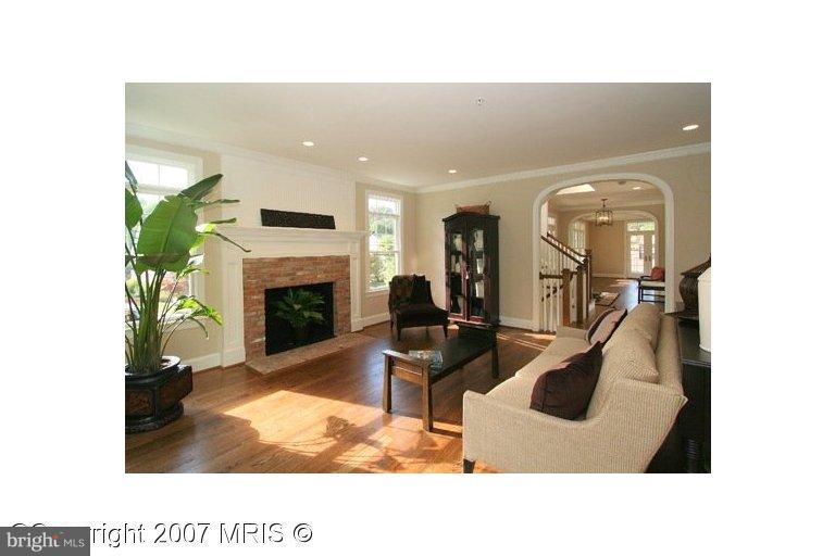 7003 Brookville Road Chevy Chase, MD 20815 - Photo 8 of 12 a living room with furniture and a fireplace