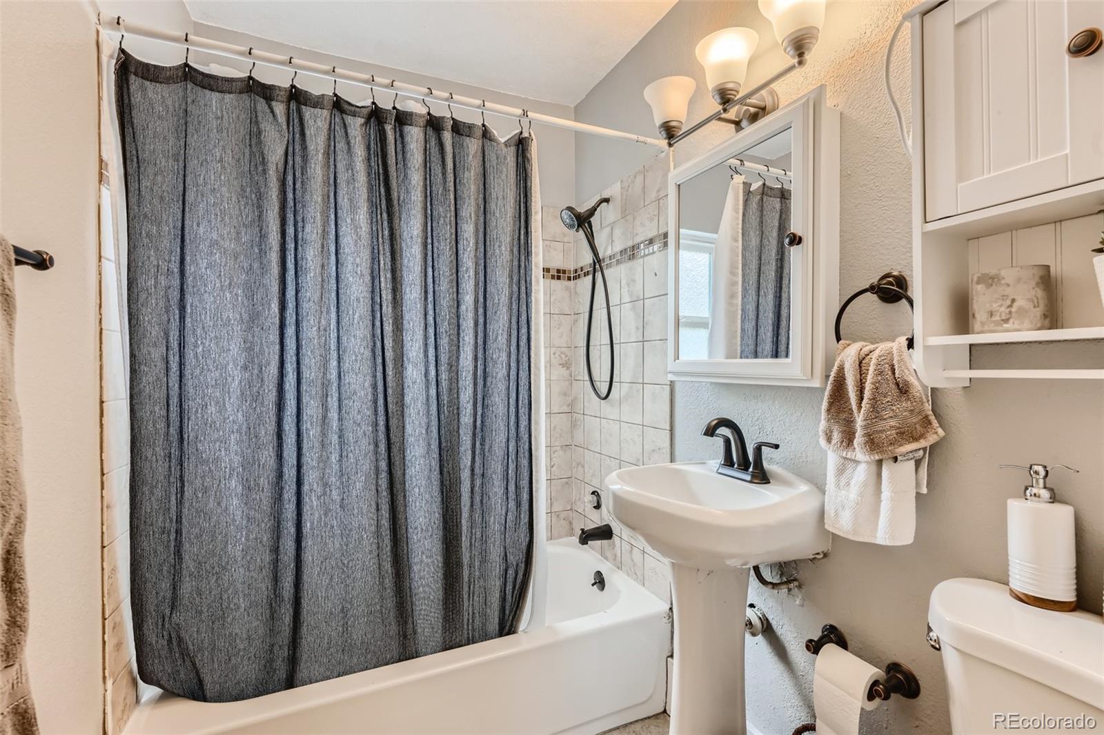 44 Julian Street Denver, CO 80219 - Photo 13 of 26 a bathroom with a sink toilet and shower