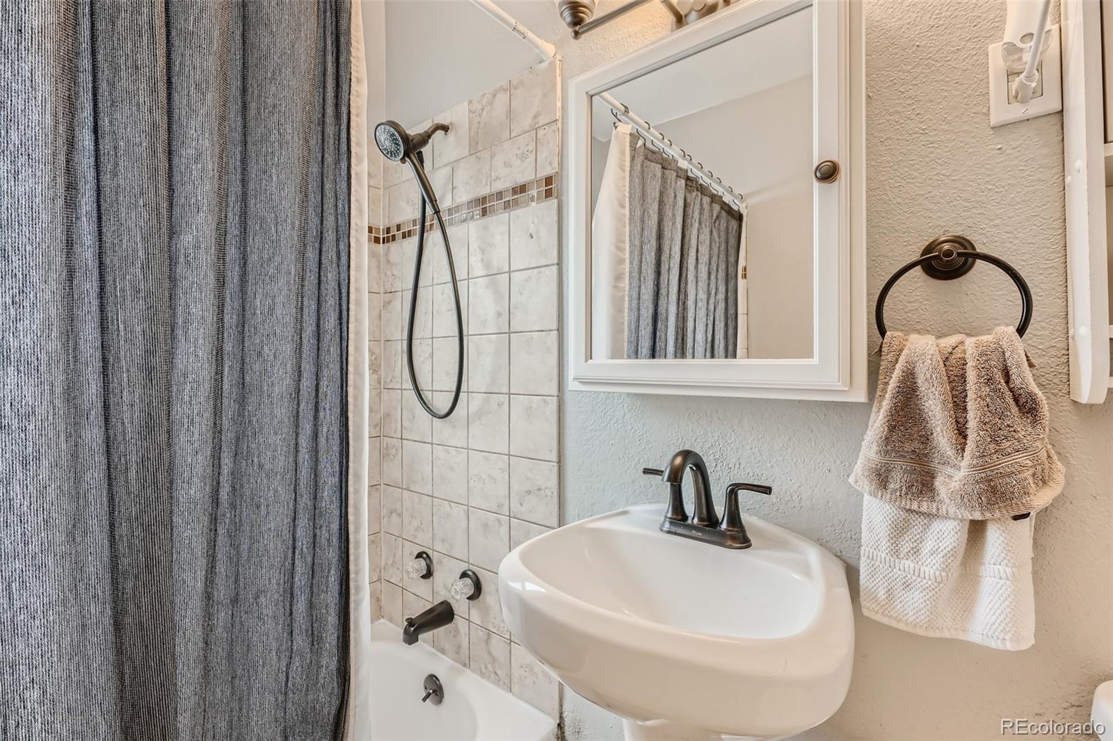 44 Julian Street Denver, CO 80219 - Photo 14 of 26 a bathroom with a sink and a mirror