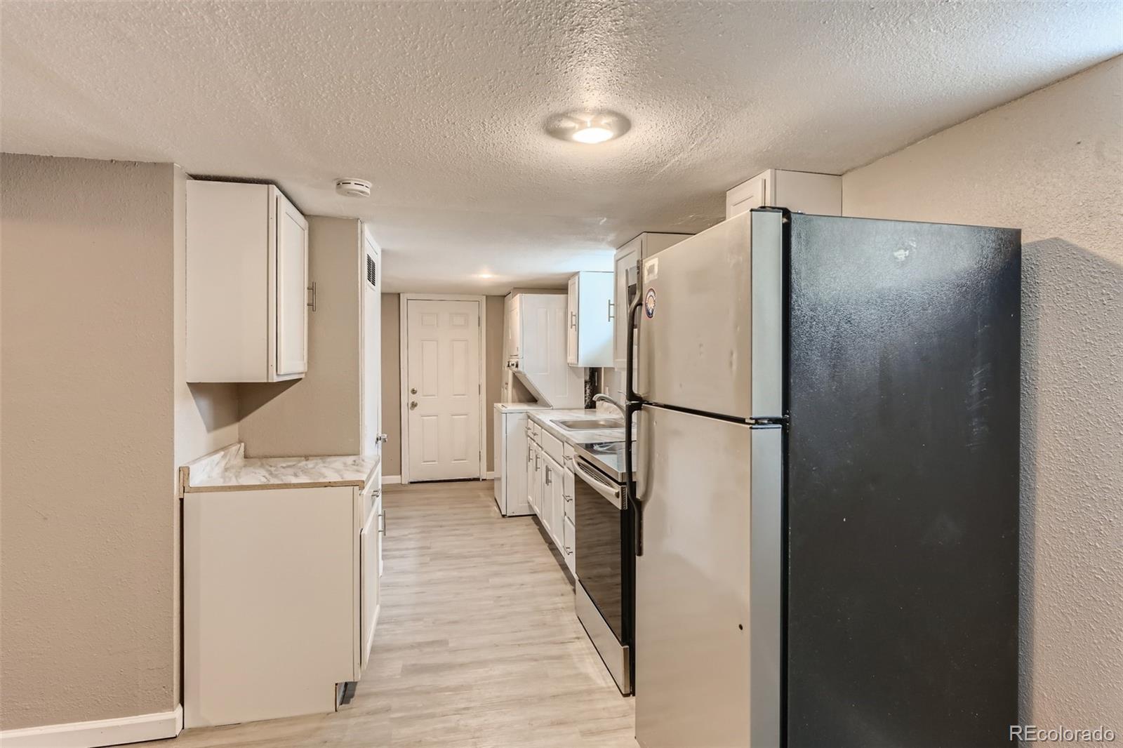 44 Julian Street Denver, CO 80219 - Photo 18 of 26 a kitchen with a refrigerator a sink and dishwasher