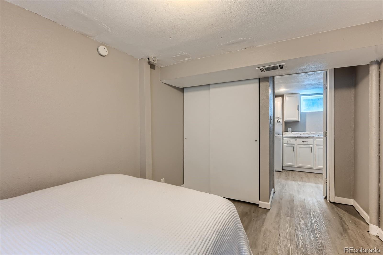 44 Julian Street Denver, CO 80219 - Photo 20 of 26 a bedroom with a bed and a view of bathroom