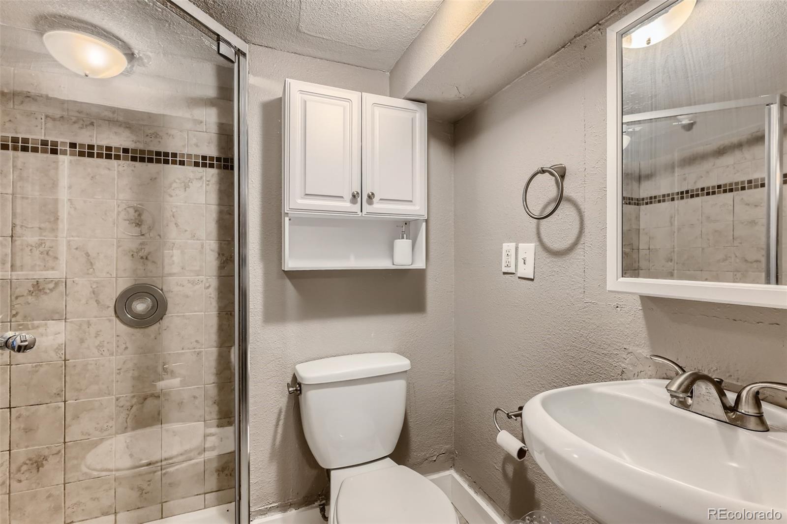 44 Julian Street Denver, CO 80219 - Photo 21 of 26 a bathroom with a toilet sink and shower