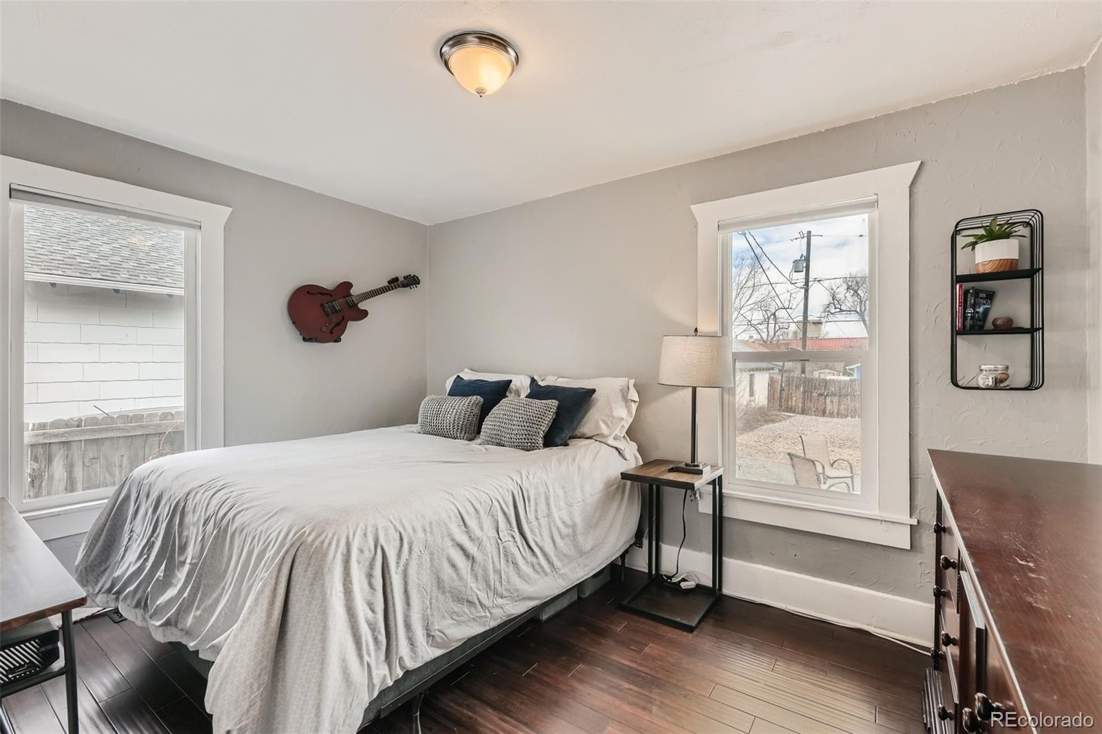 44 Julian Street Denver, CO 80219 - Photo 10 of 26 a bedroom with a bed and wooden floor