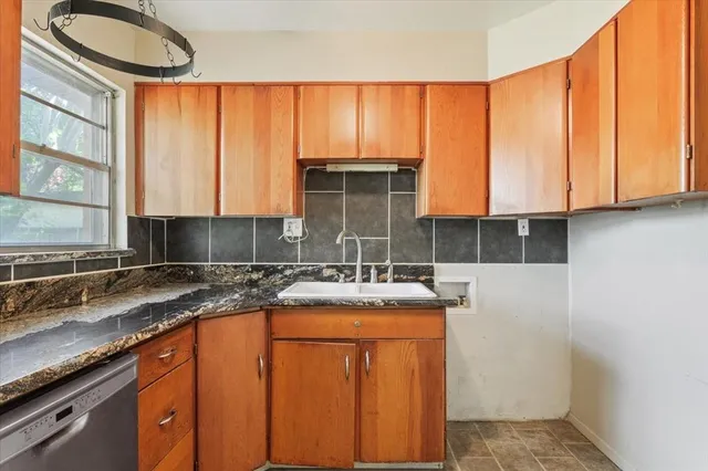 a kitchen with stainless steel appliances granite countertop a sink a stove and a microwave