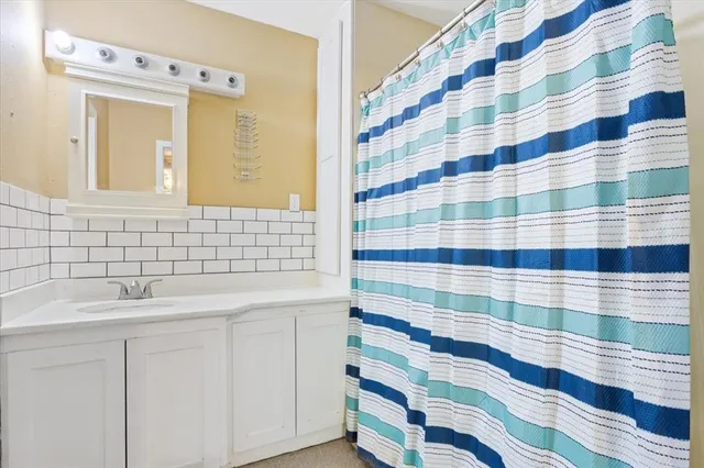 a bathroom with a sink a mirror a shower and a sink