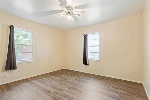 wooden floor in an empty room with a window