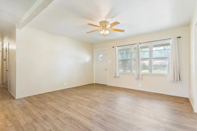 a view of an empty room with a window