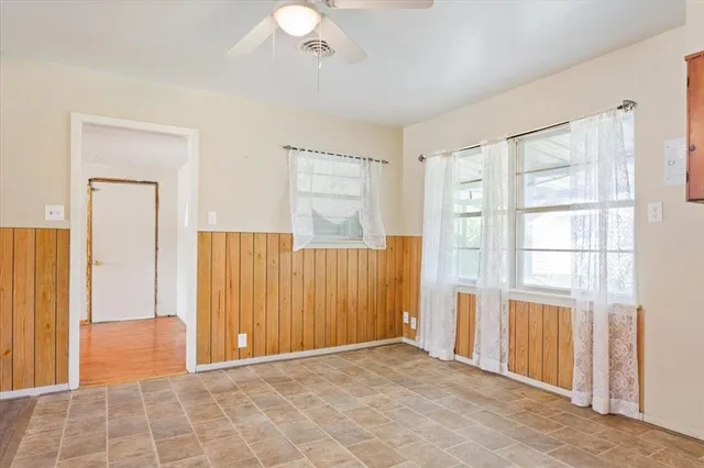 an empty room with windows and closet