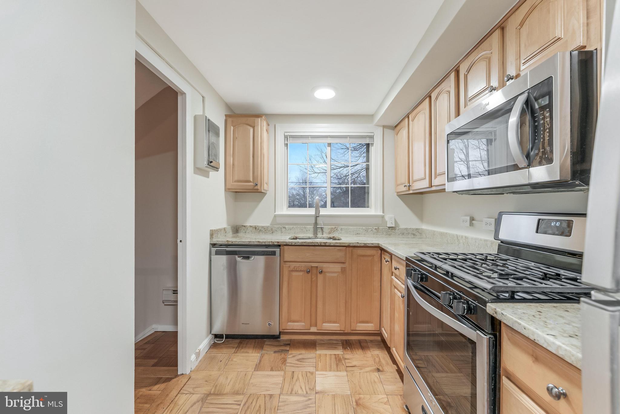 3228 Wellington Road Alexandria, VA 22302 - Photo 6 of 20 a kitchen with stainless steel appliances granite countertop a stove and a sink
