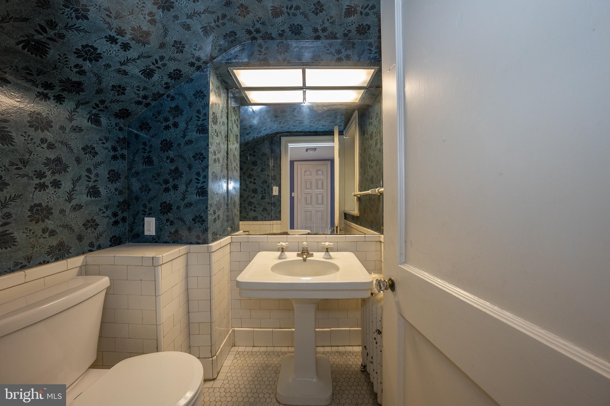 451 Merion Road Merion Station, PA 19066 - Photo 14 of 42 a bathroom with a sink toilet and mirror