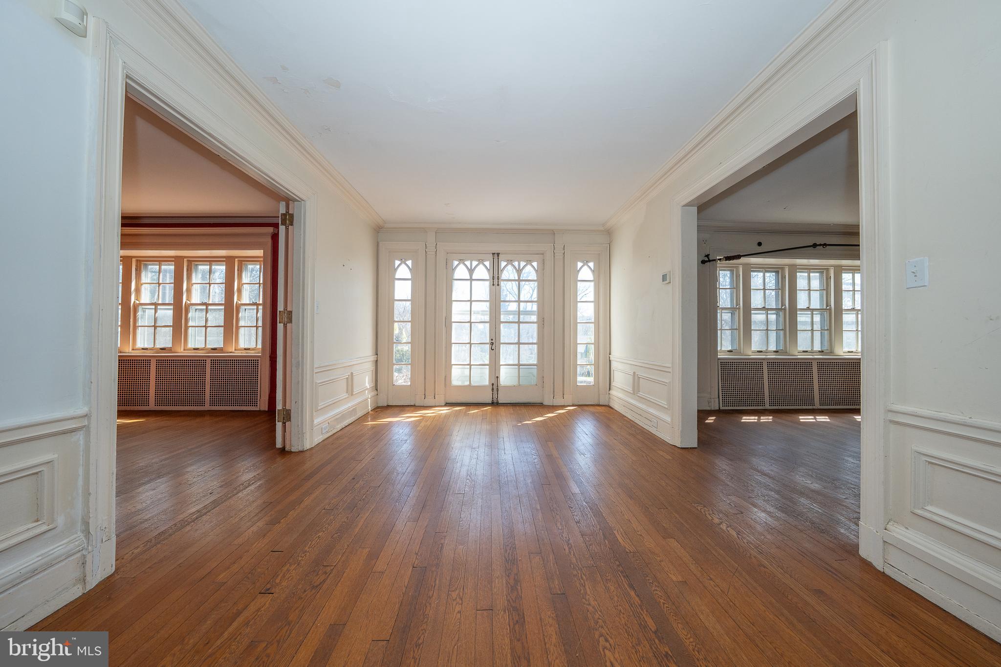 451 Merion Road Merion Station, PA 19066 - Photo 7 of 42 an empty room with wooden floor and windows