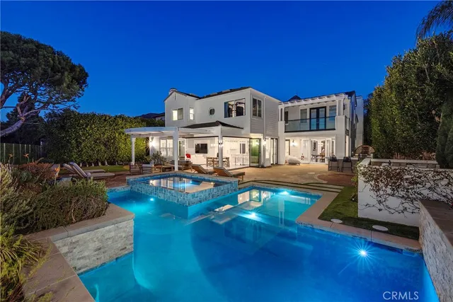 a view of a house with swimming pool yard and sitting area