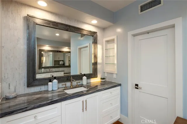 a bathroom with a sink and a mirror