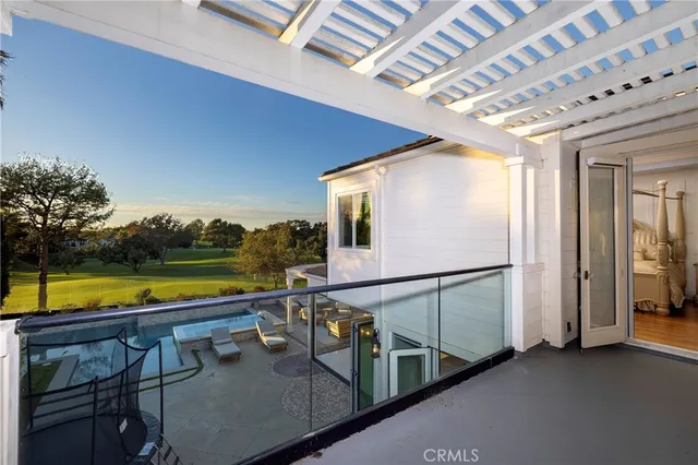 a view of a swimming pool with outdoor seating and plants