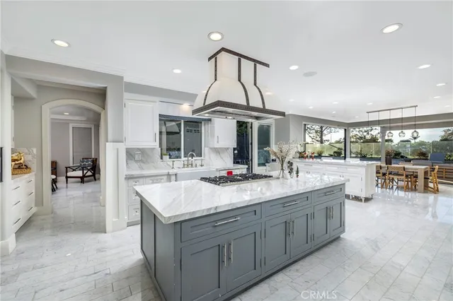 a kitchen with stainless steel appliances granite countertop a sink stove and cabinets