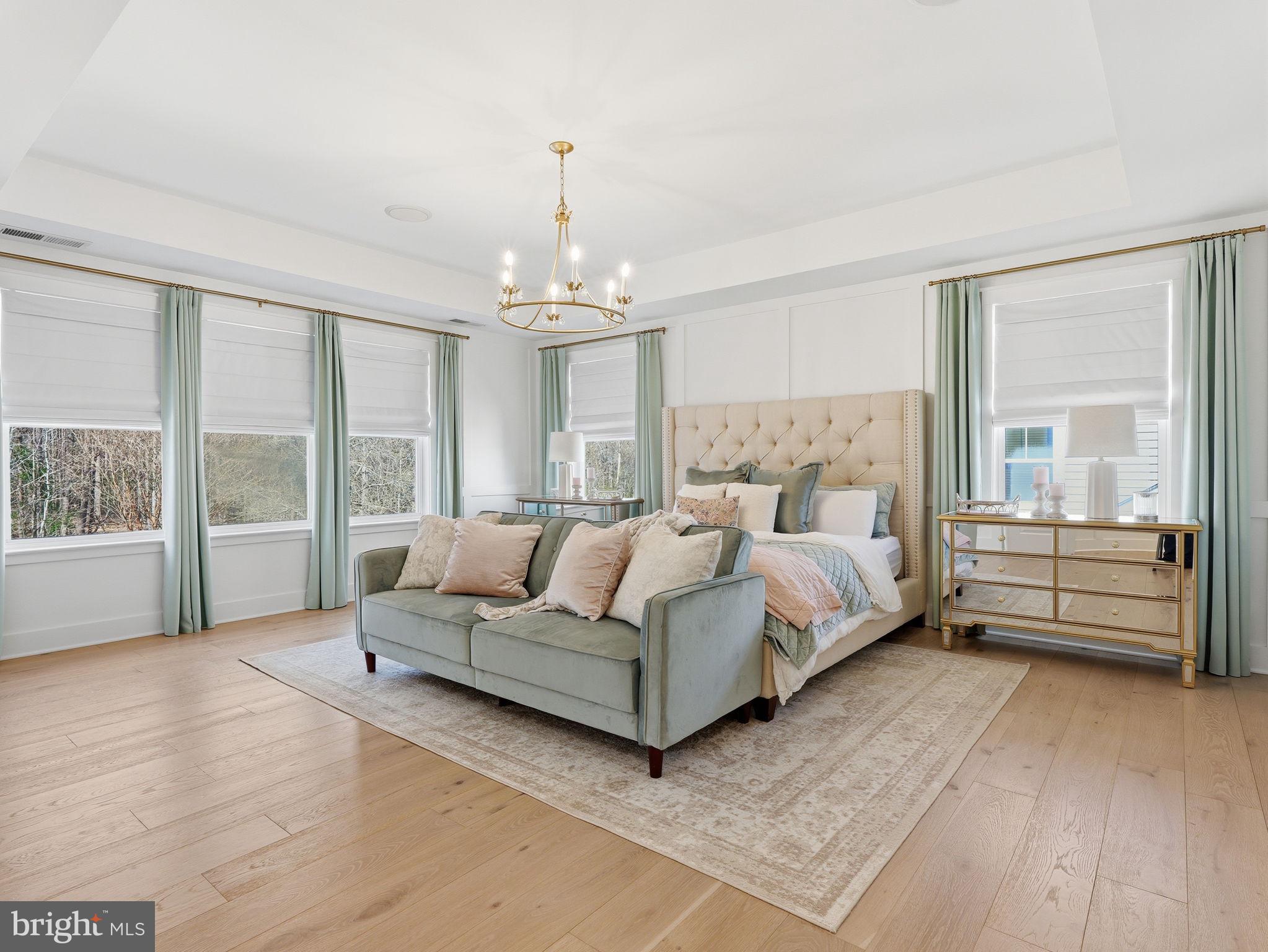 17210 Perinchief Street Ruther Glen, VA 22546 - Photo 18 of 39 a spacious bedroom with a bed a large window and chandelier
