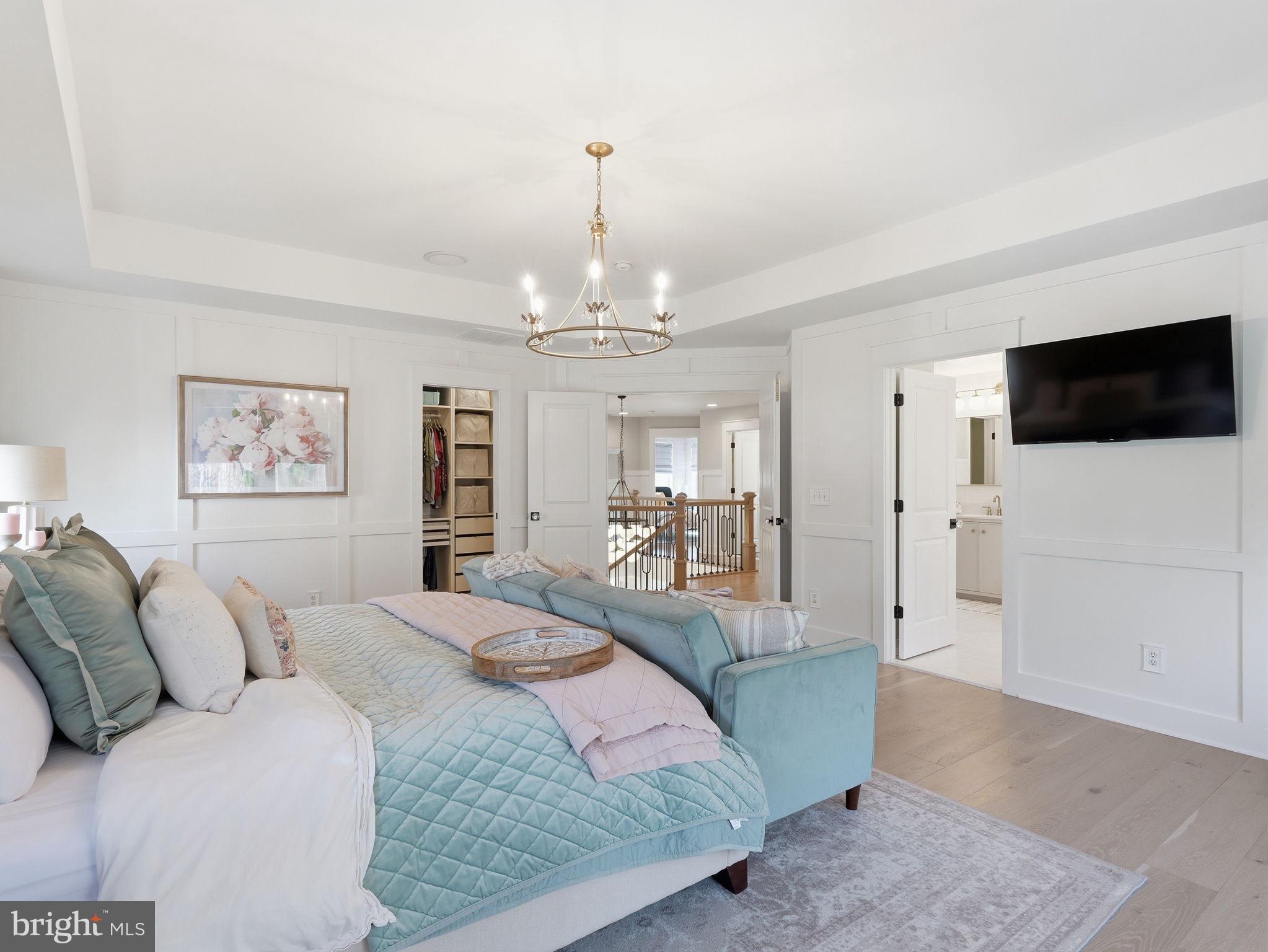 17210 Perinchief Street Ruther Glen, VA 22546 - Photo 20 of 39 a large bedroom with a bed and a flat screen tv