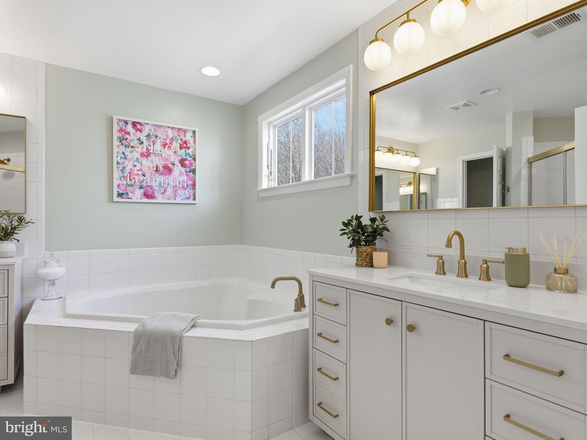 17210 Perinchief Street Ruther Glen, VA 22546 - Photo 21 of 39 a bathroom with a bathtub a sink a mirror and vanity