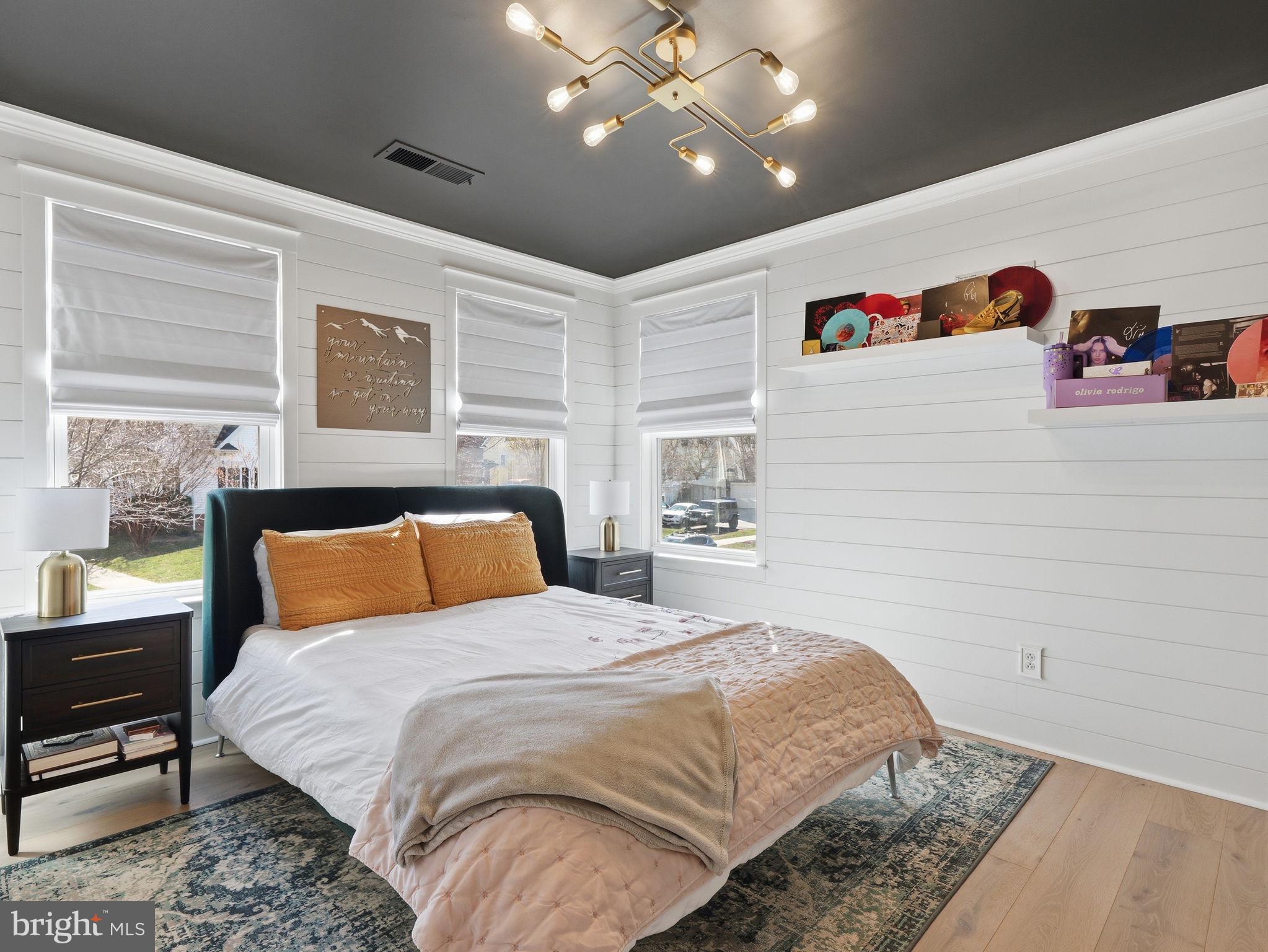 17210 Perinchief Street Ruther Glen, VA 22546 - Photo 26 of 39 a bedroom with a large bed and a chandelier