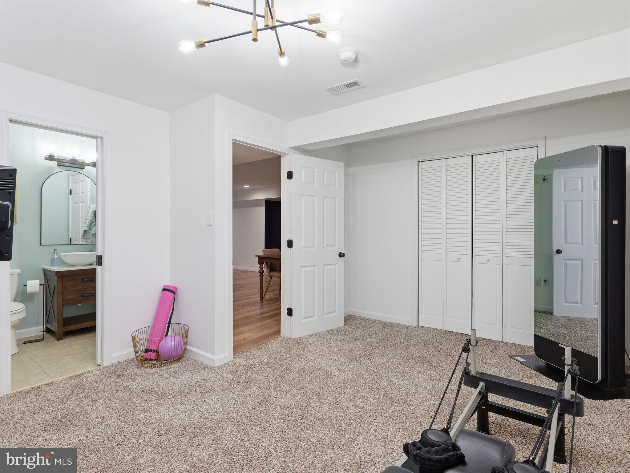 17210 Perinchief Street Ruther Glen, VA 22546 - Photo 34 of 39 a living room with furniture gym equipment and a fireplace