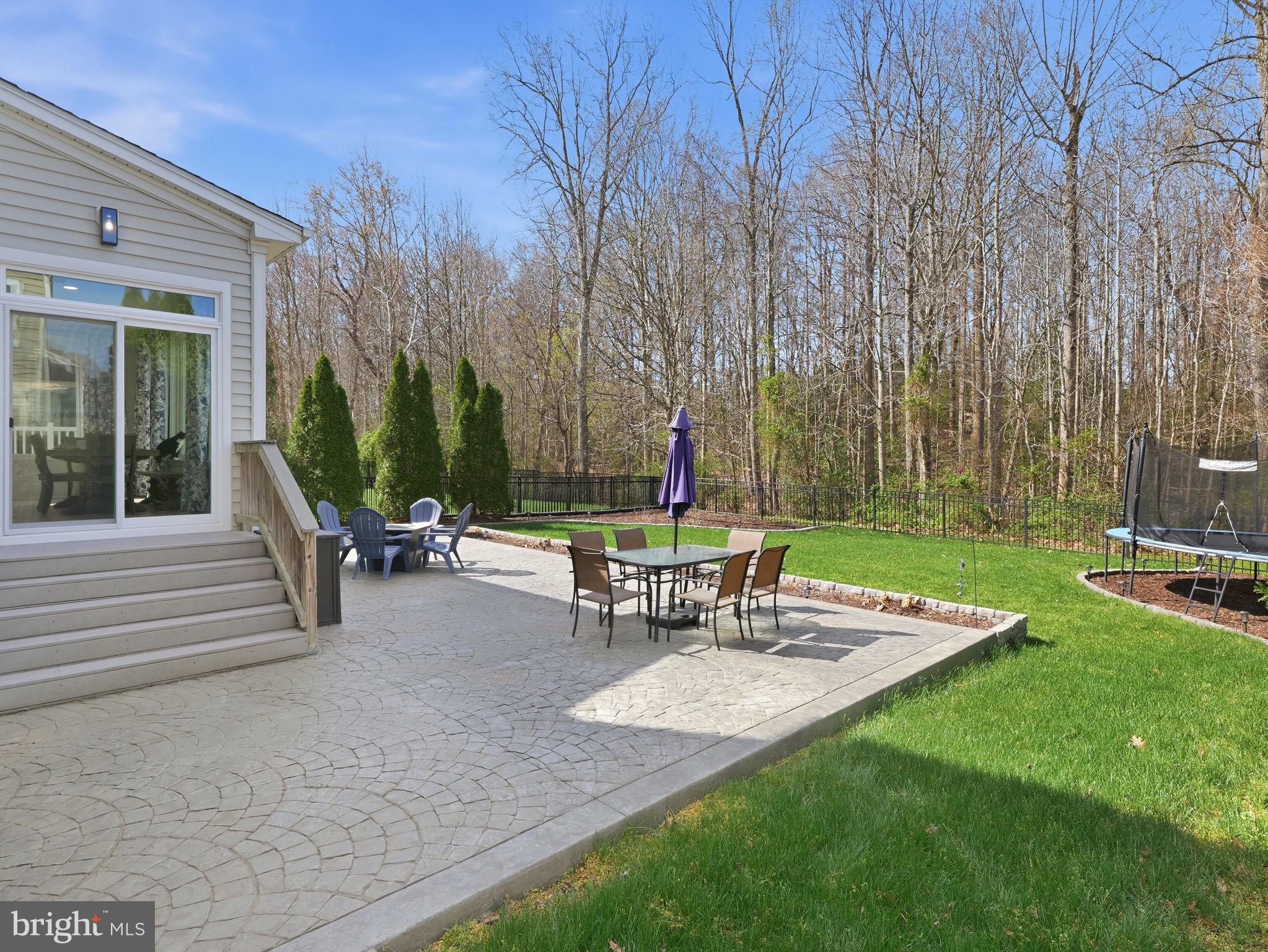 17210 Perinchief Street Ruther Glen, VA 22546 - Photo 39 of 39 a view of a chair and table in backyard of the house