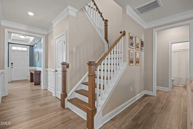 a view of a hallway with wooden floor and stairs