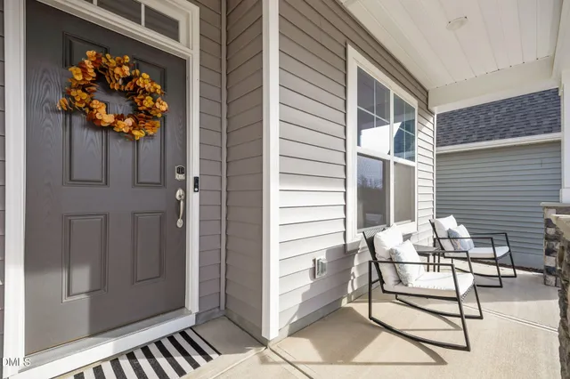 a balcony with table and chairs