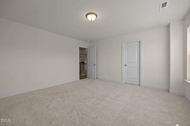 a view of an empty room with a closet