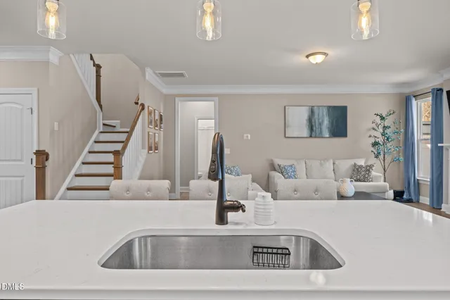 a kitchen with a sink and mirror