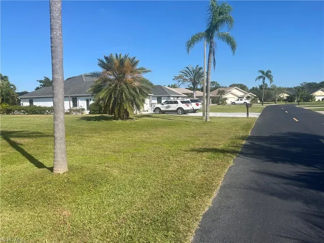 a view of a yard and front view of a house