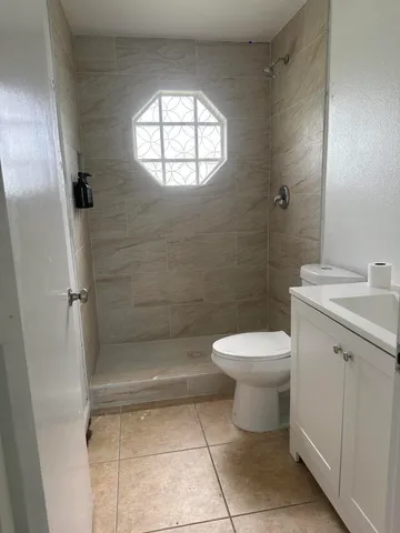 a bathroom with a toilet sink and shower