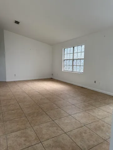 a view of an empty room with a window