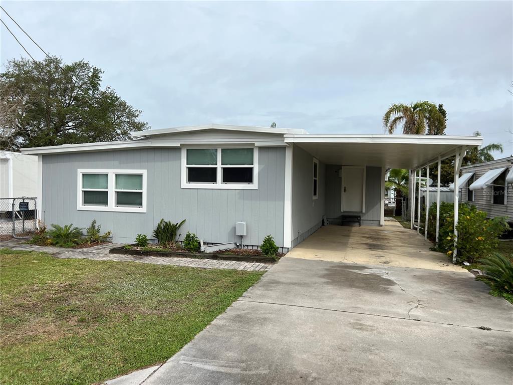 6837 Flicker Lane Hudson, FL 34667 - Photo 1 of 1 a front view of house with yard
