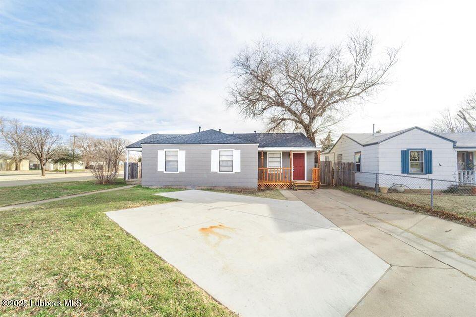 2503 30th Street Lubbock, TX 79410 - Photo 1 of 21 a front view of a house with a yard and garage