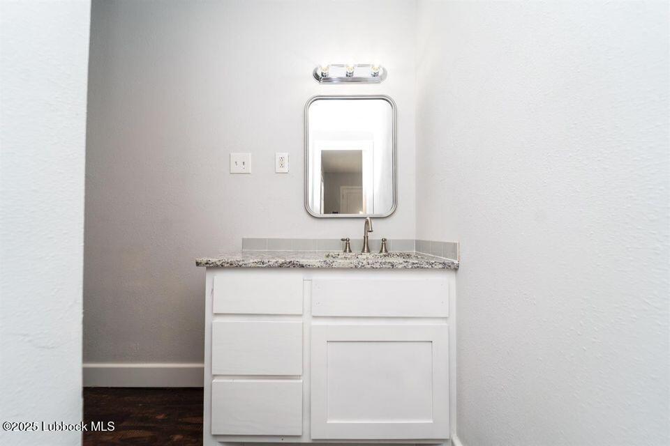 2503 30th Street Lubbock, TX 79410 - Photo 12 of 21 a bathroom with a sink and a mirror