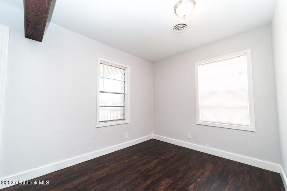 2503 30th Street Lubbock, TX 79410 - Photo 3 of 21 an empty room with wooden floor and windows