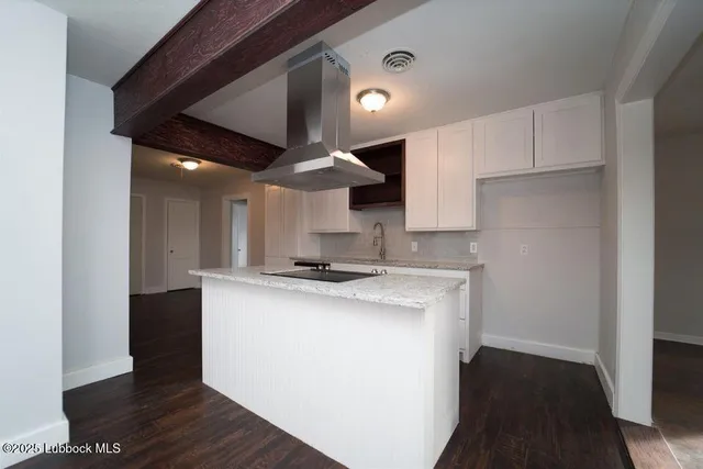 a kitchen with stainless steel appliances a sink a stove a refrigerator and cabinets