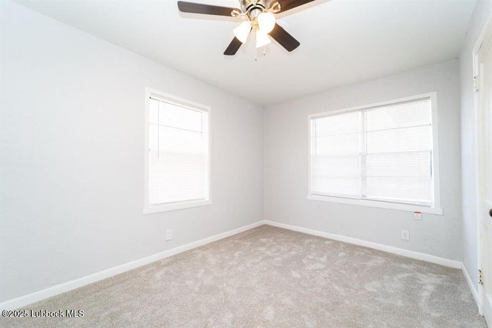 2503 30th Street Lubbock, TX 79410 - Photo 8 of 21 an empty room with a window and a fan